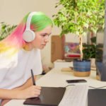 a person wearing headphones and sitting at a desk